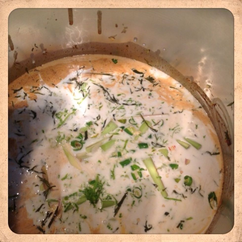 Add lemongrass, chilies, and lime leaves. Bring soup to a light boil.