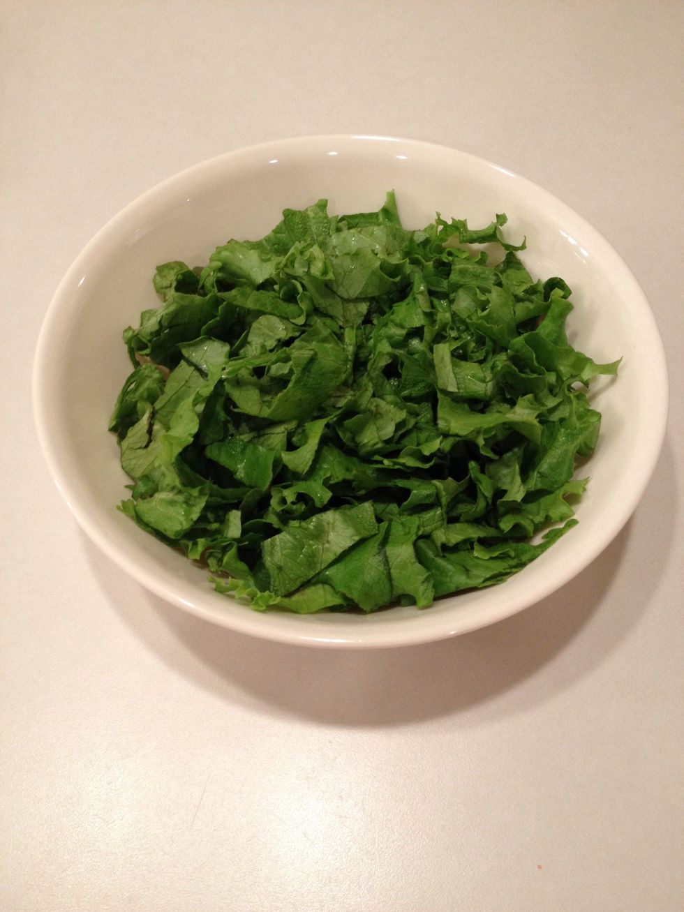 Add lettuce to a serving bowl.