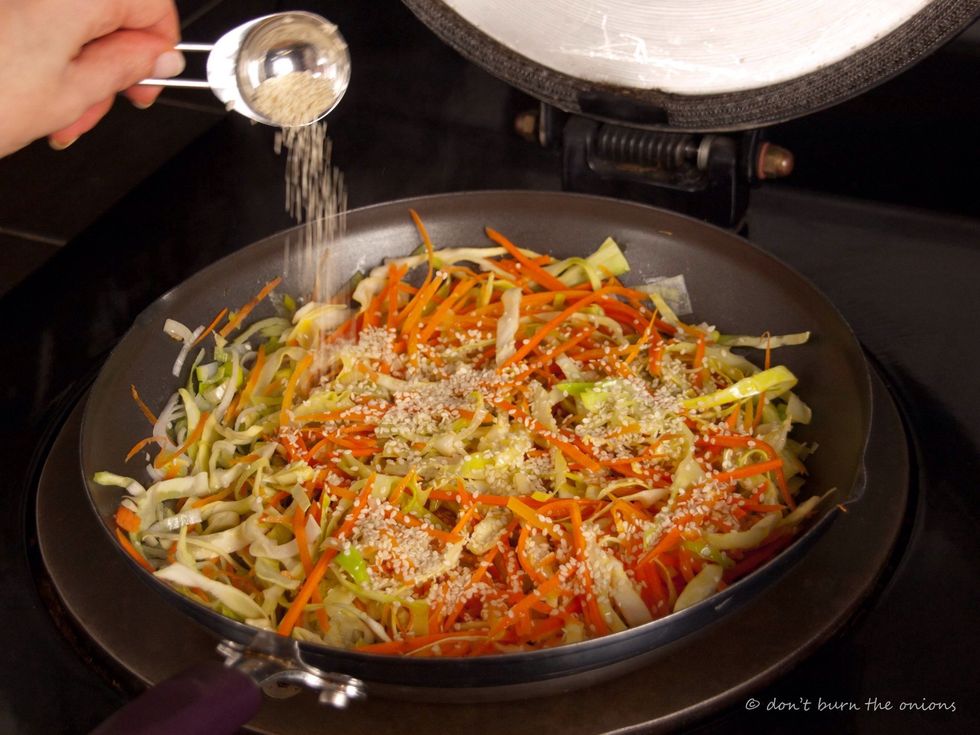 Add lots of protein packed sesame seeds and fry for another minute to toast. Stir to ensure they don't burn!