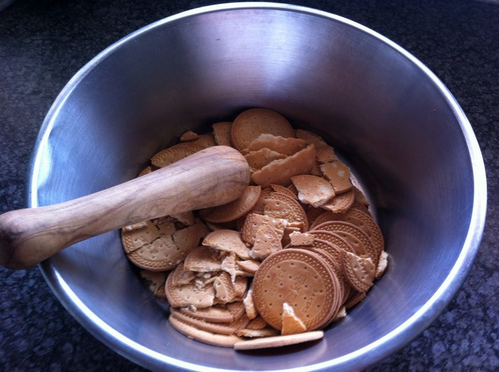 Add Marie Biscuits to a large bowl and crush.
