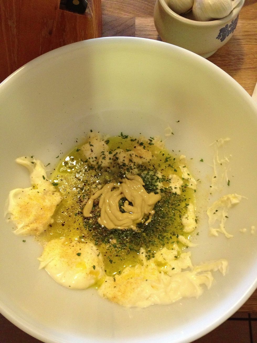 Add mayonnaise, Dijon mustard, white wine vinegar, olive oil, dried parsley, salt and pepper to a large mixing bowl.