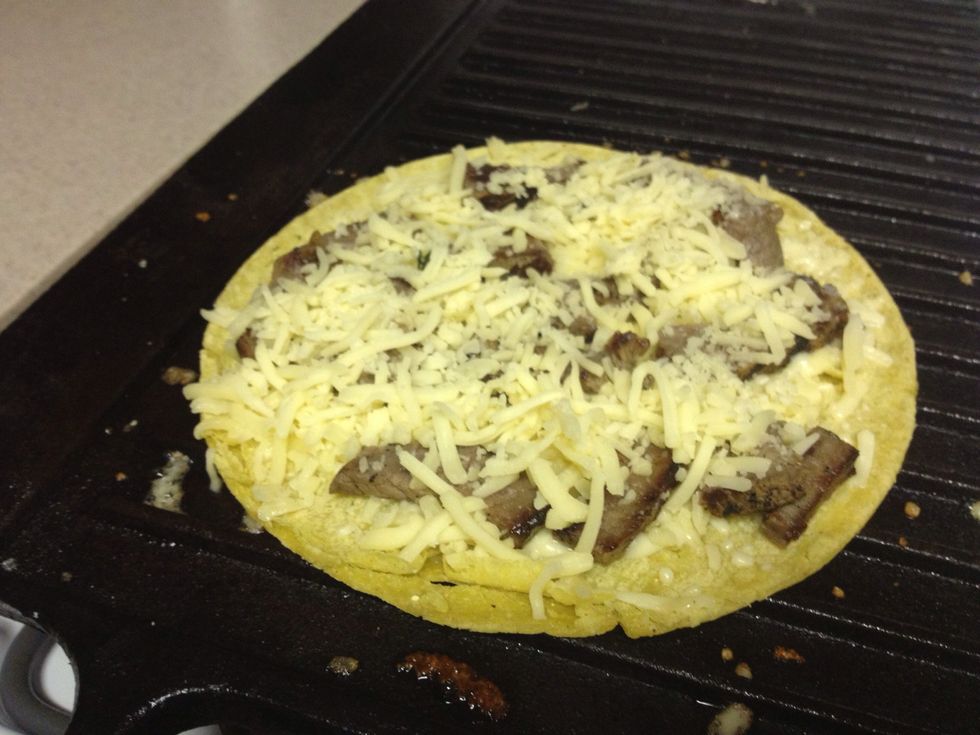 Add meat and top with the rest of cheese.
