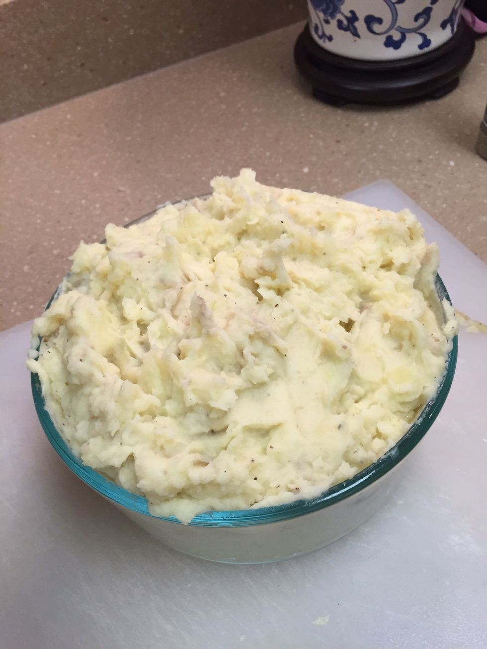 Add meat mixture into the middle. Spread a thick layer of potatoes (1-2 inches thick) onto the top as to form a potatoes crust on the top.