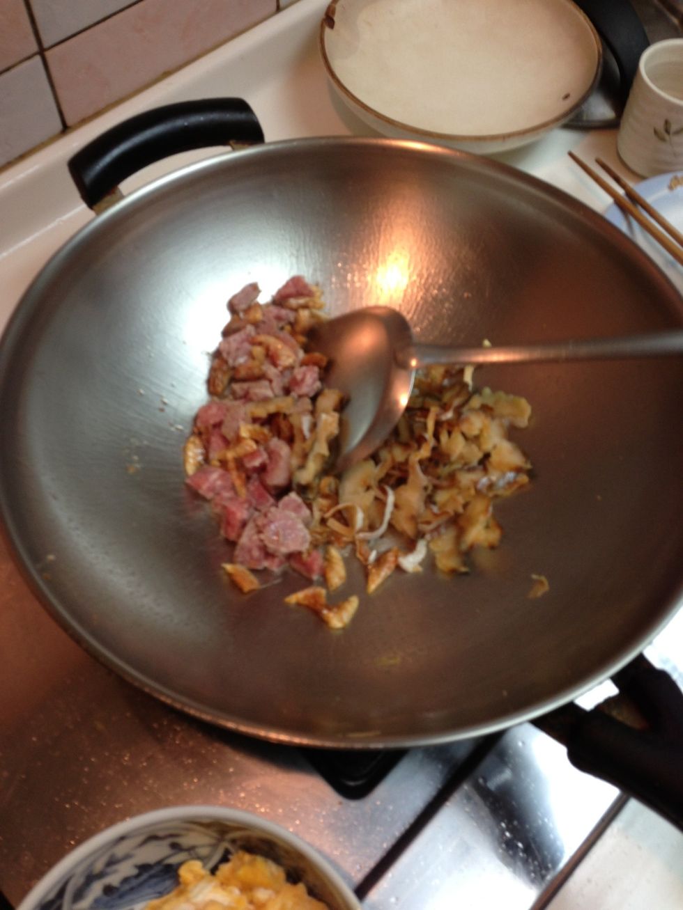 Add meats together and fry with oil