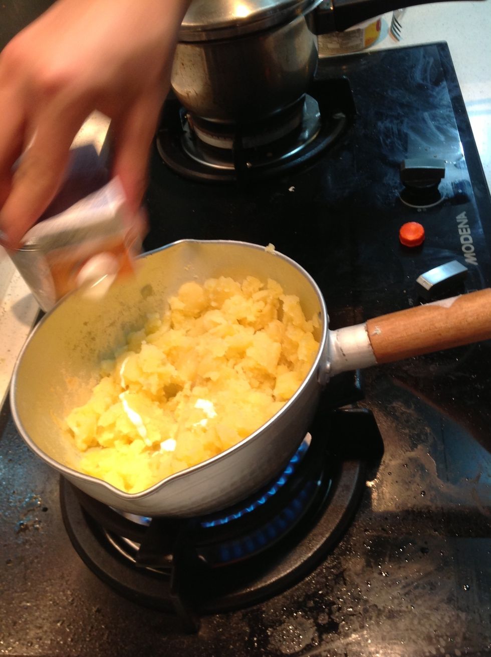 Add milk and continue mashing your potato