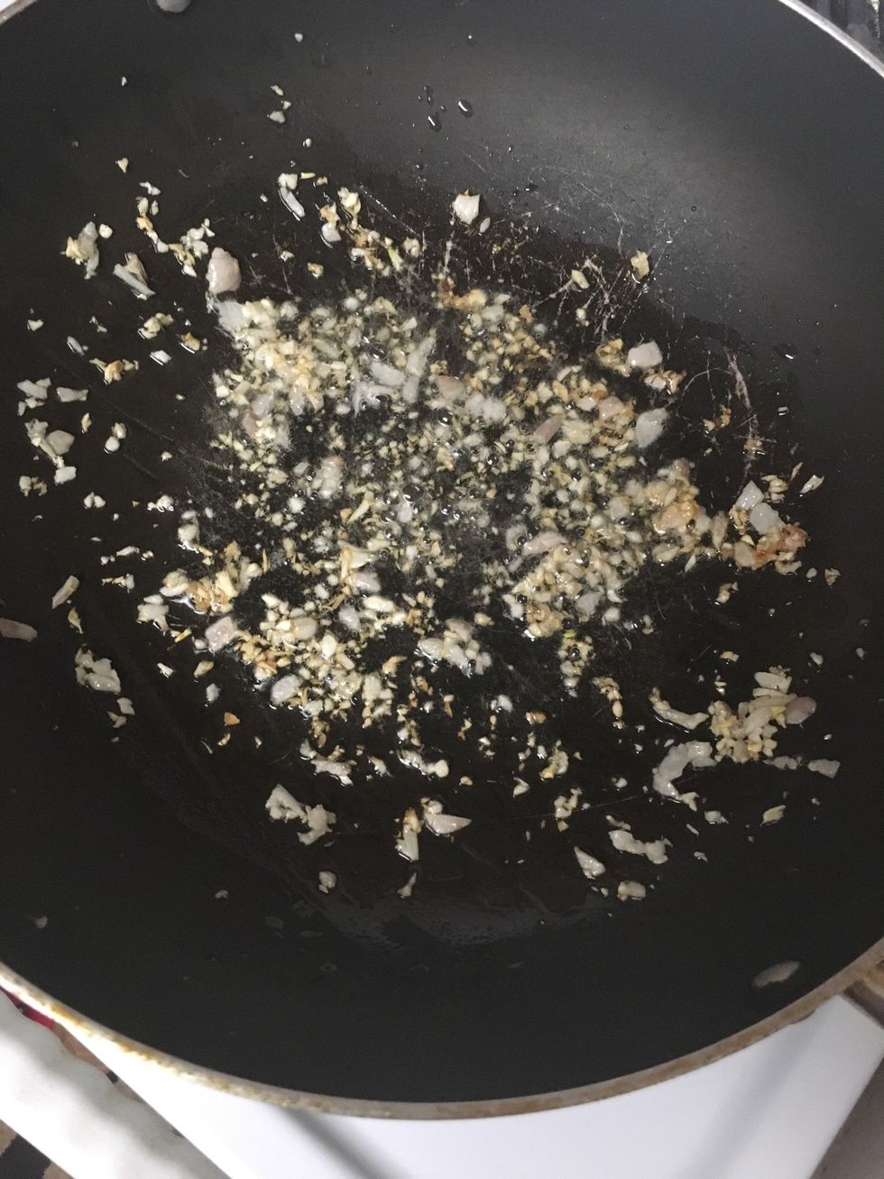 Add minced garlic and minced purple onion to oil