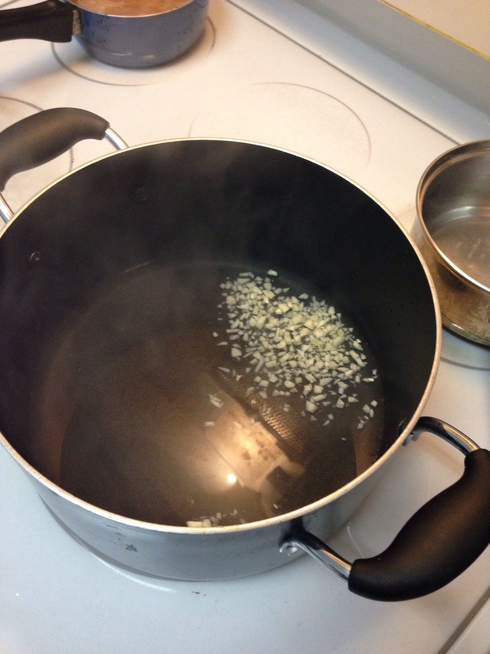 Add minced garlic and water in a pan. Being to a boil.