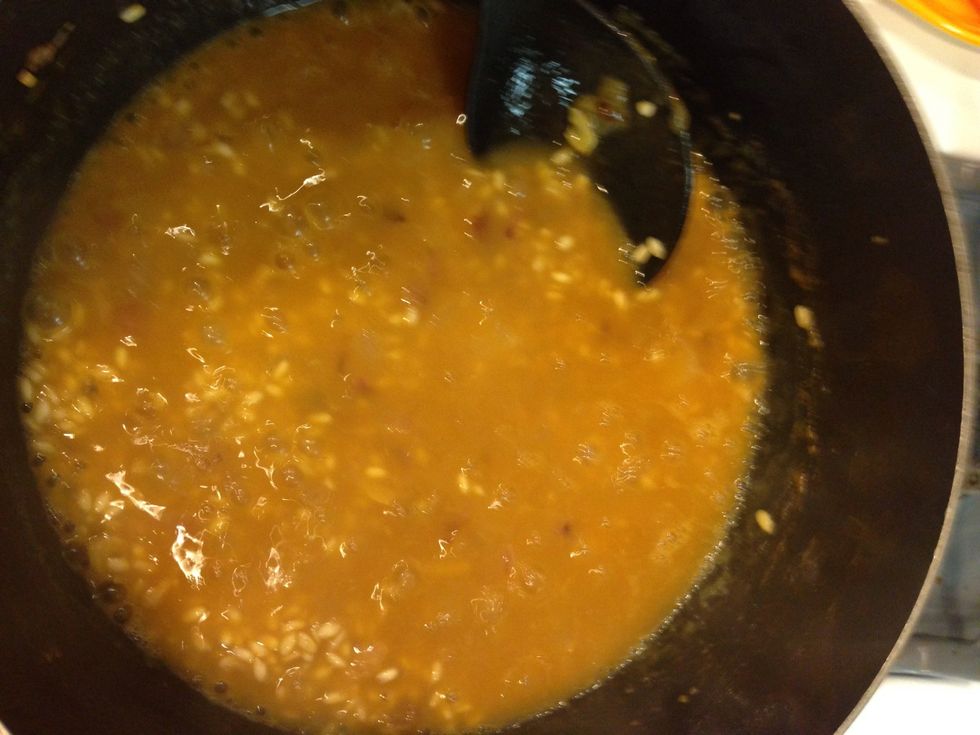 Add more broth, enough to cover the rice. You will keep repeating these steps until the broth is gone.