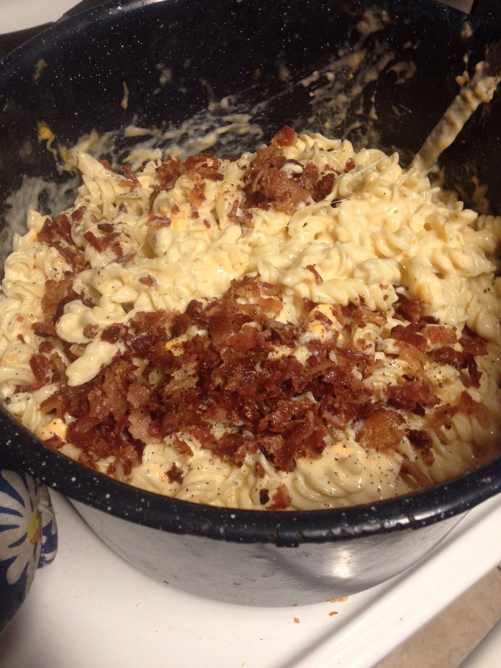 Add more cheese and milk until creamy and cheese is melted. Then add chopped bacon. And green onions. Mix well.