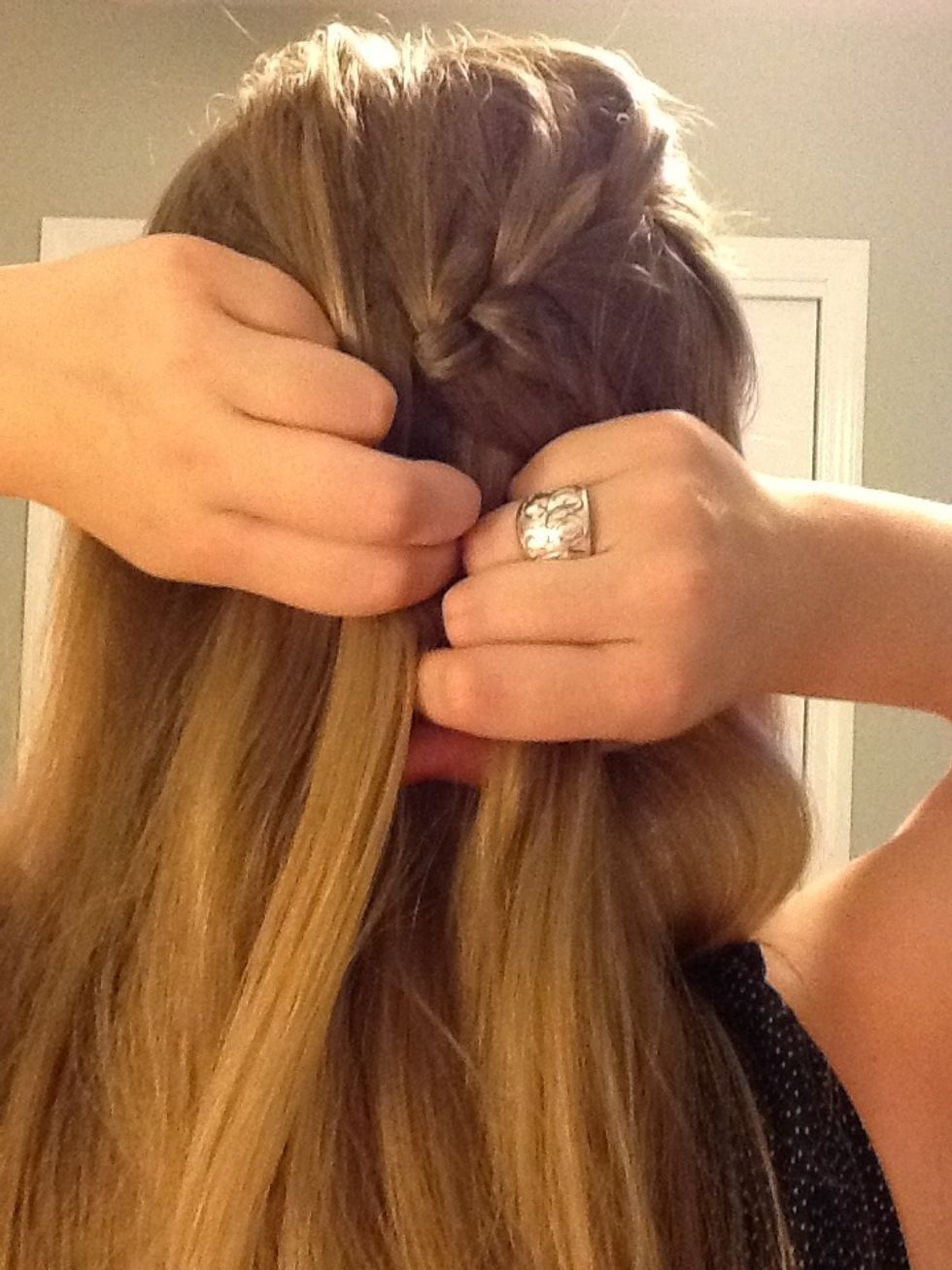 Add more hair to the left section of hair. Cross it over so it becomes the middle section of hair.