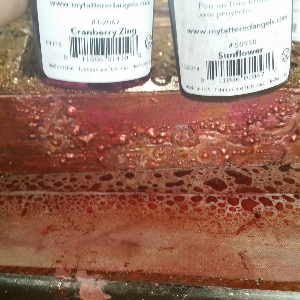 Add more layers of mist to coat the papers and help them blend into the frame, giving the illusion for texture. Then heat set it for even more bubbles.