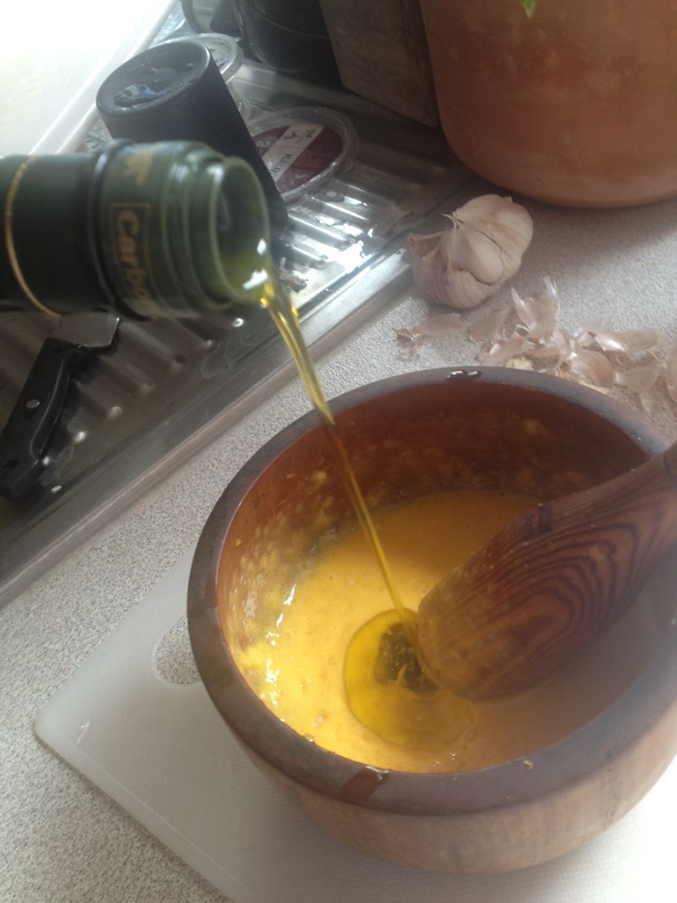Add more olive oil while grinding when the aioli starts to get thick. Keep grinding and grinding and grinding. It should look smoother now.