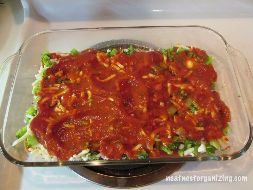 Add more sauce (use about half of what is left. Spread evenly being sure to completely cover ravioli.