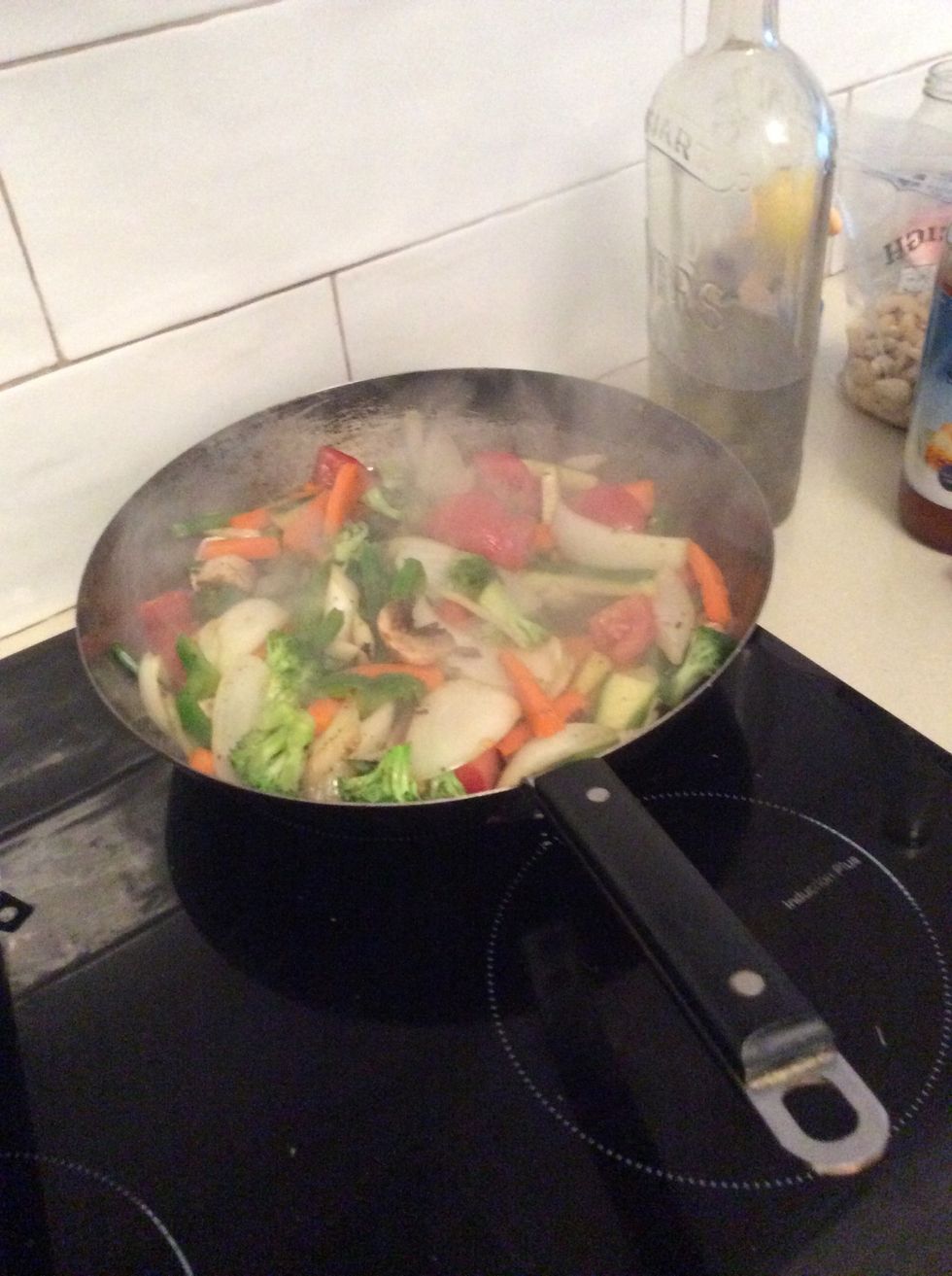 Add mushrooms, broccoli and zucchini to the frying vegetables.