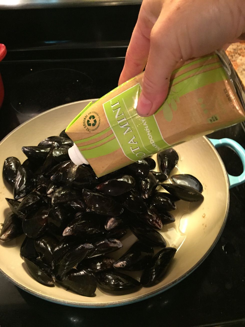 Add mussels to pot, add wine. I used half a carton ... About 6 oz
