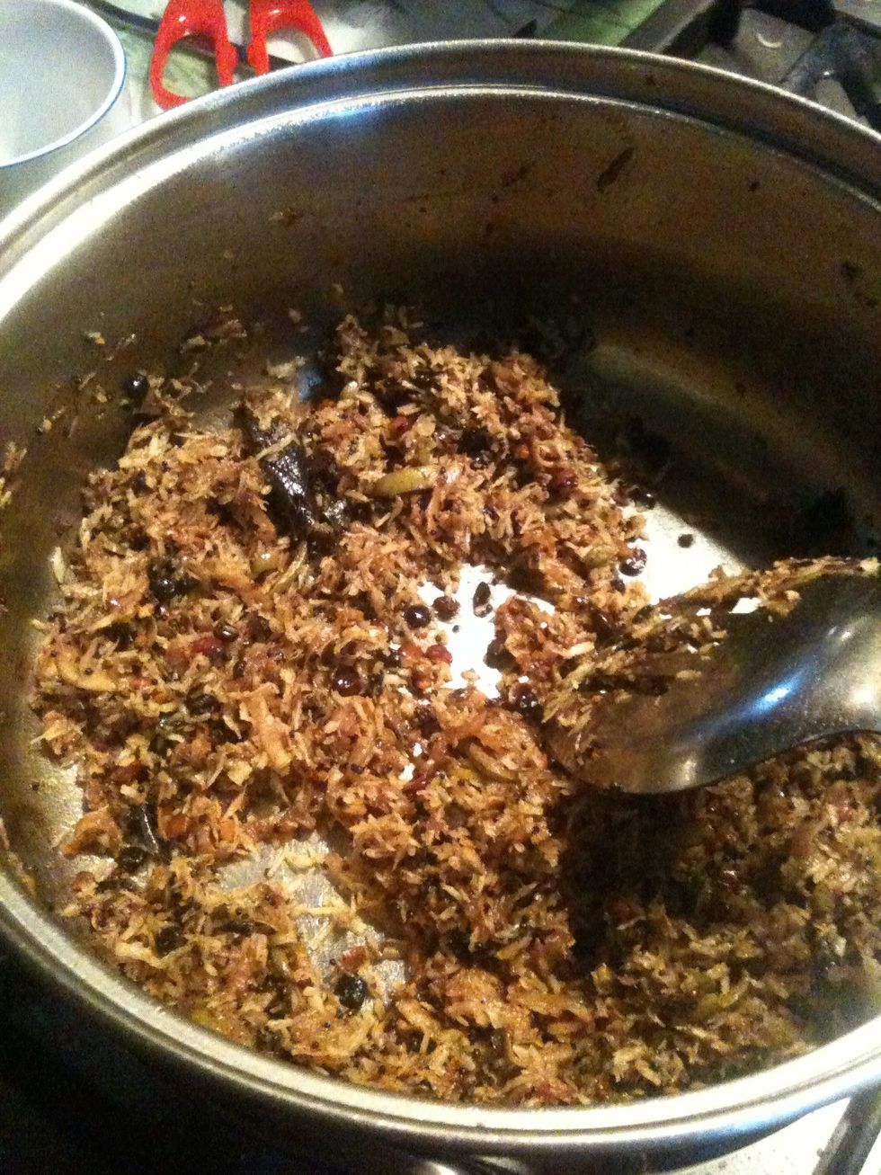 Add mustard seeds,asafetida, curry leaves,green chili, Dal, turmeric powder, ground nut.Keep it on low flame and fry for half a min add grated mango n ground coconut n fry for 11/2 min until soft