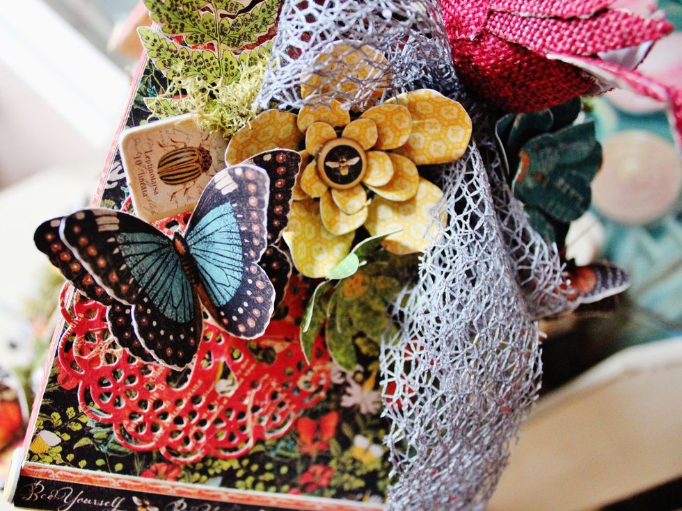 Add net bow to top of birdhouse with more prepared flowers and butterflies.