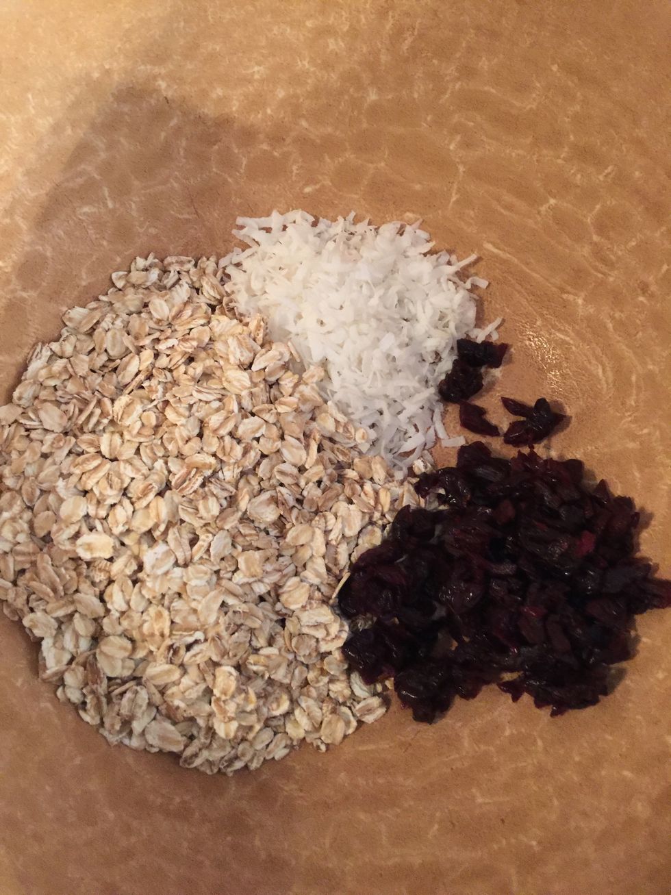 Add oats, coconut flakes, cherries to bowl