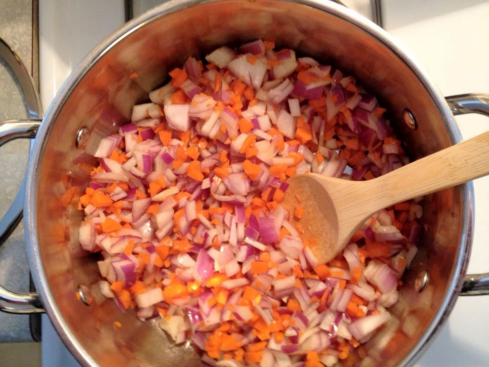 Add oil to large pot. When hot, add carrots and onions and saut\u00e9 until soft (about 2 minutes).