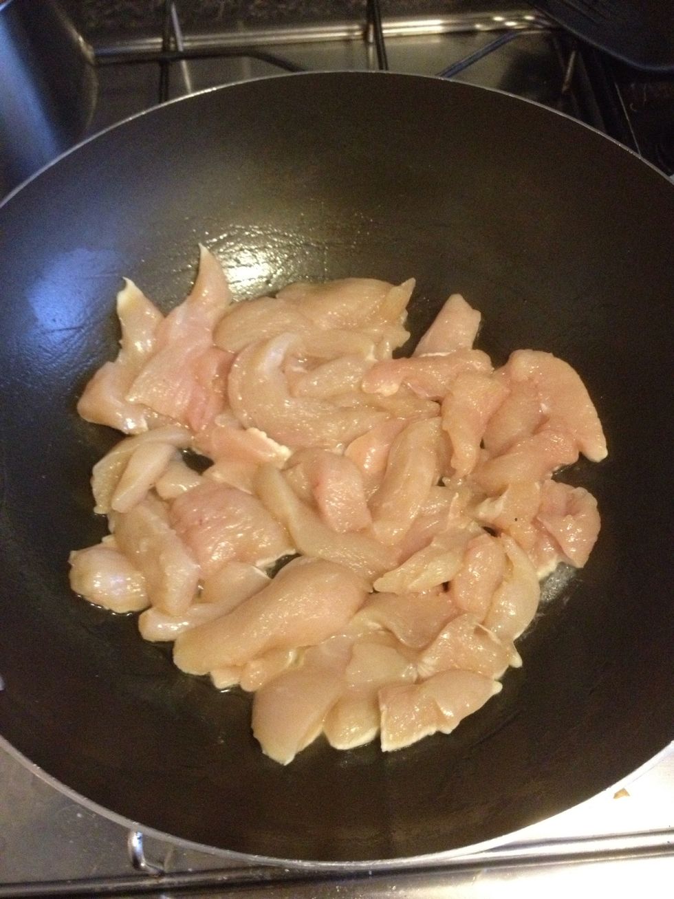 Add oil to the pan and cook the sliced chicken until browned off (white)