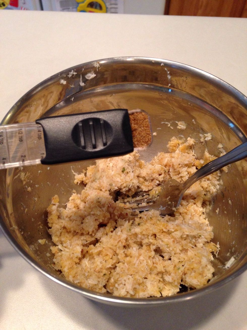 Add Old Bay seasoning (use more if you really like a spicy, seafood taste.) Add salt and pepper and mix again.
