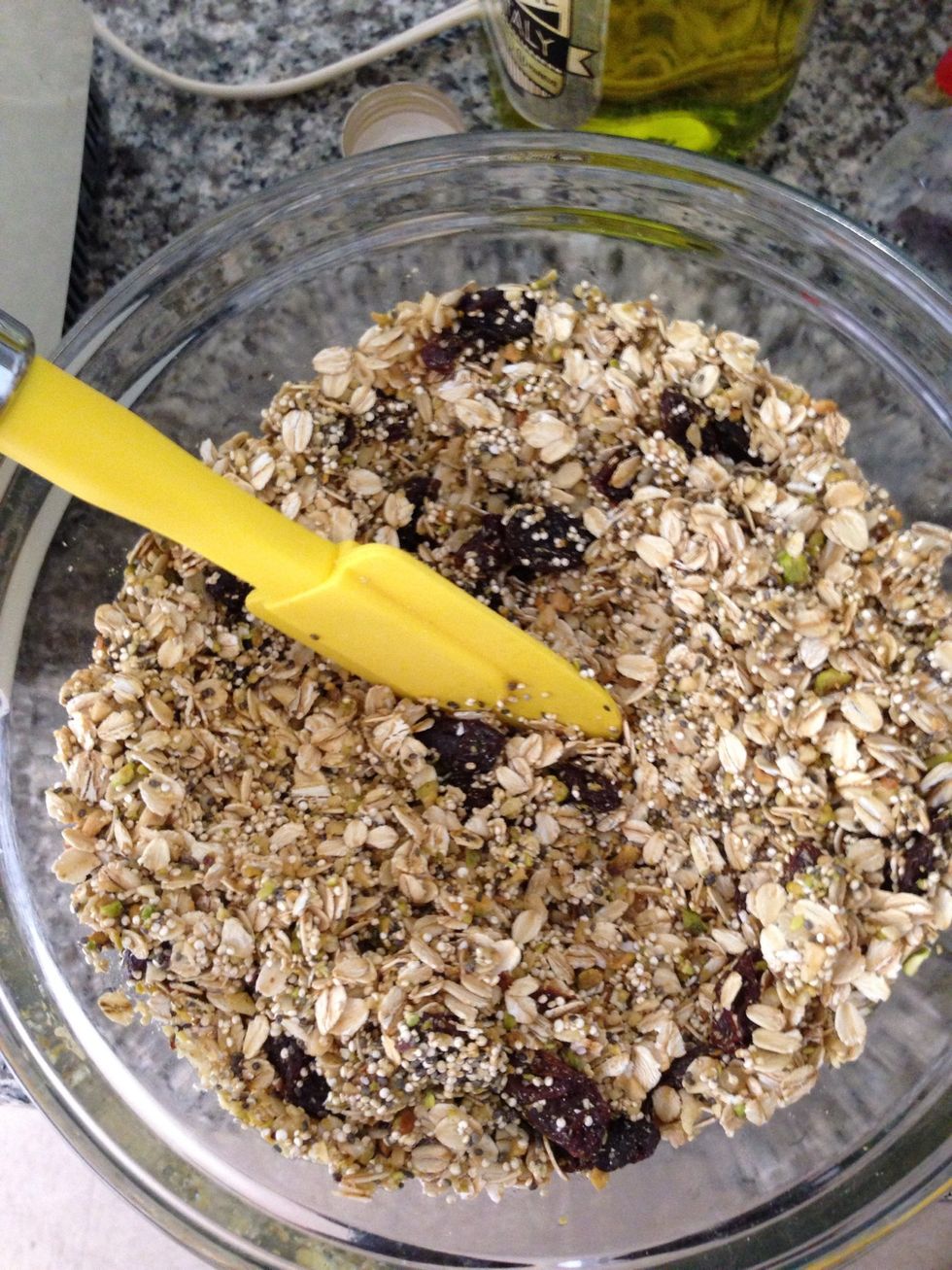 Add olive oil (3 tablespoons) and honey (2 tablespoons) to dry ingredients and stir thoroughly. If you tend to like sweet-tasting granola, add slightly more honey.