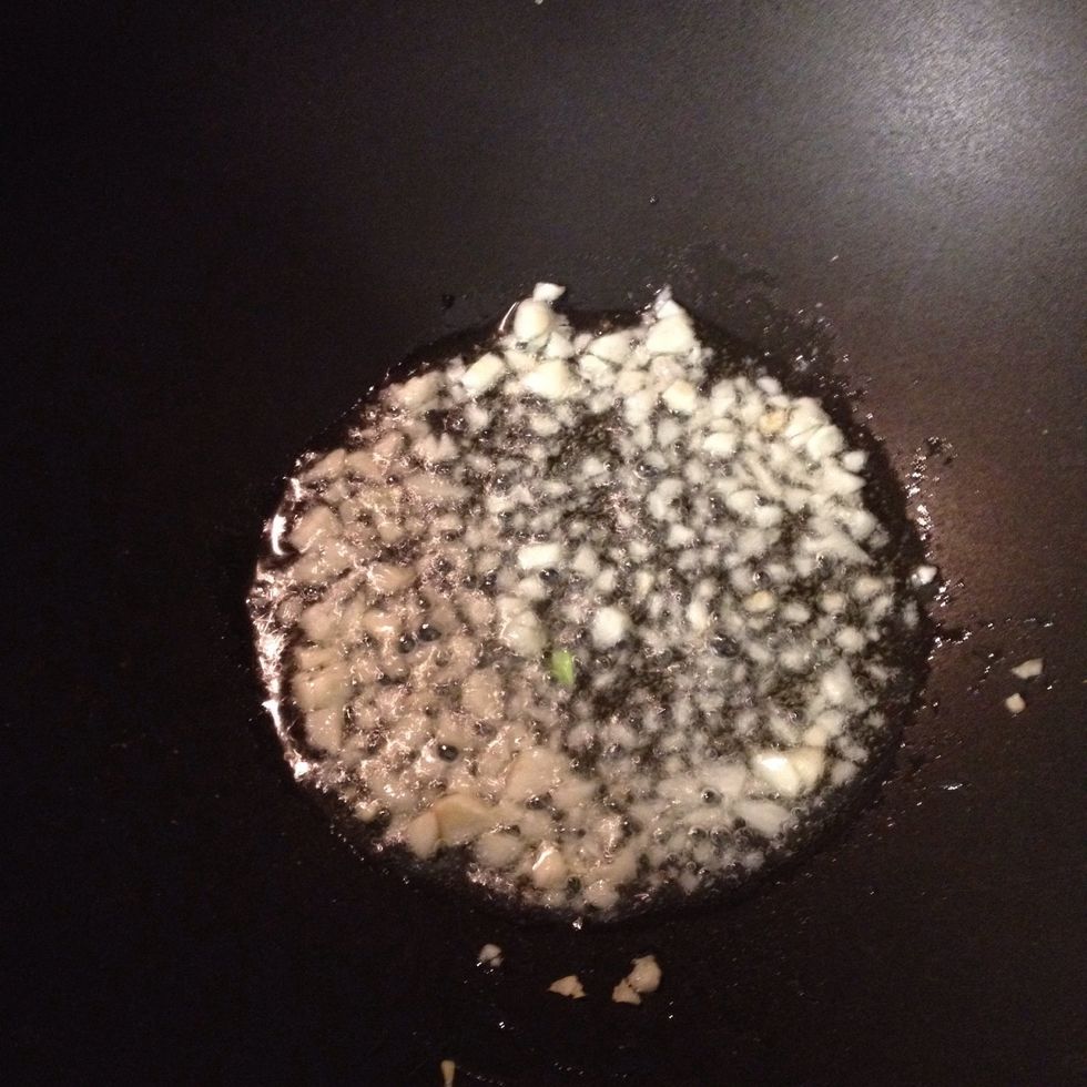 Add olive oil and garlic to your wok