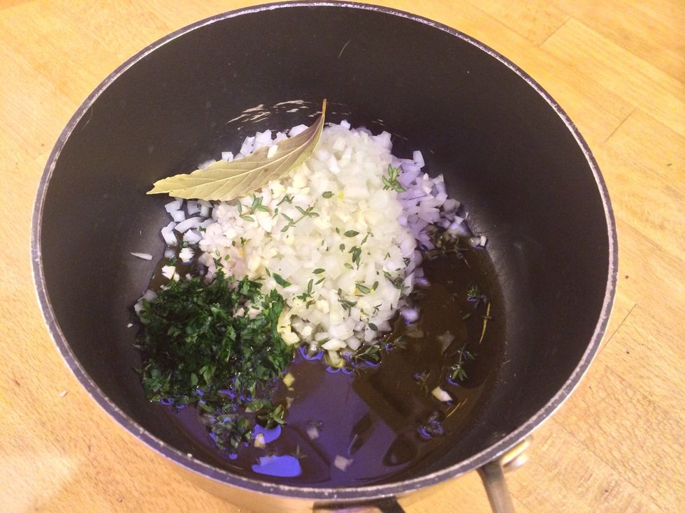 Add olive oil, onion, garlic, chopped herbs and bay leaf in this order to a hot pan and fry till the onions are soft.