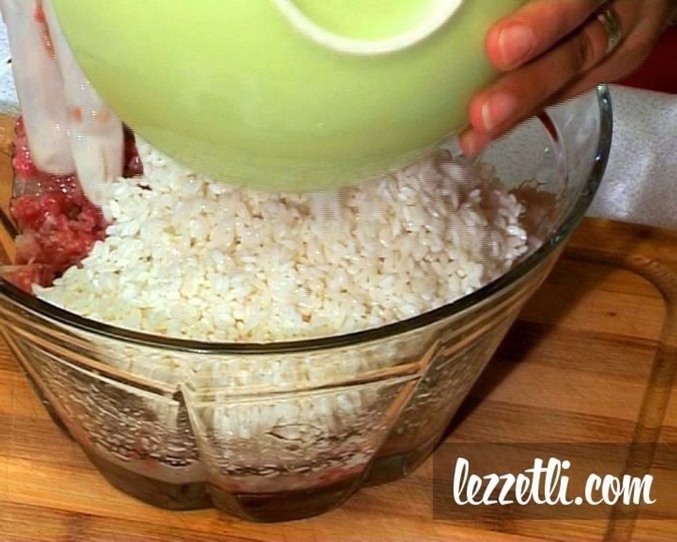 Add olive oil , planed onion and soaked rice in ground beef and knead it
