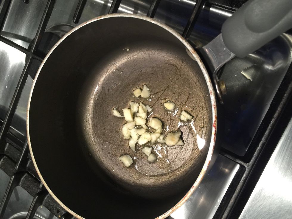 Add olive oil then garlic pieces.