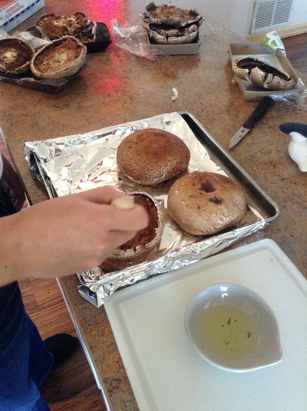 Add olive oil to small bowl then dip a pastry brush into bowl.Brush the mushrooms with olive oil