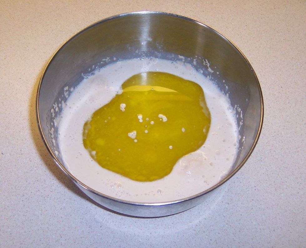 Add olive oil to yeast mixture.