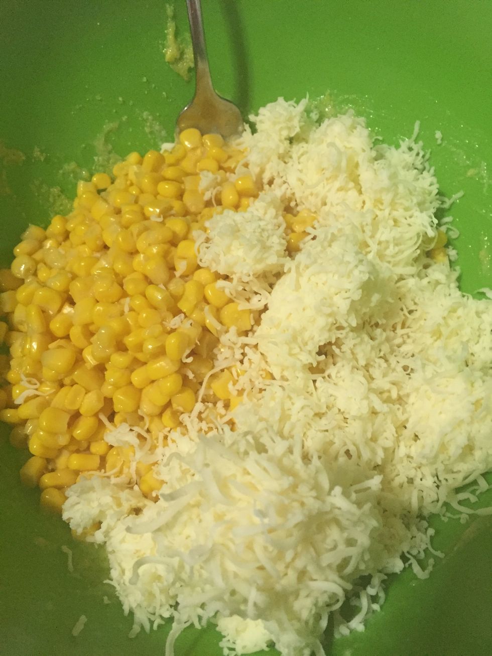 Add one can of corn and one cup of shredded cheese. I used shredded pepper jack cheese on mine.