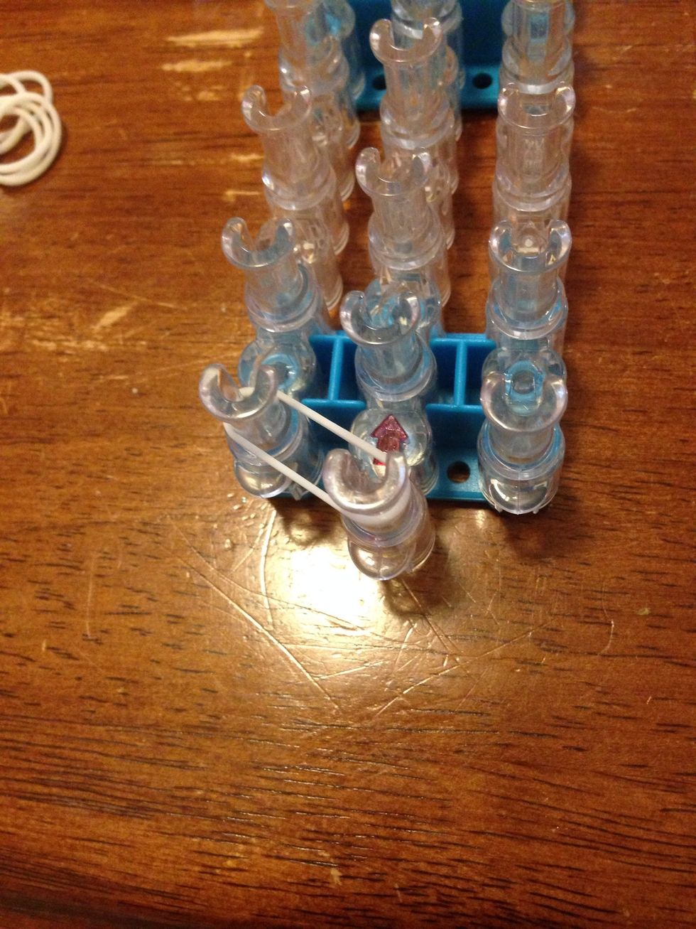 Add one colour band from the first middle to the first left pin.