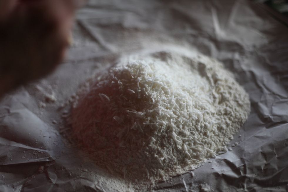 Add one cup of dedicated and one cup of shredded coconut to the flour.
