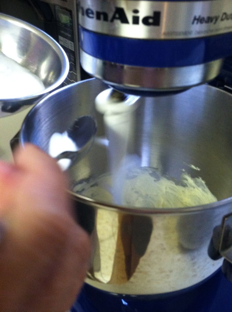 Add one cup of sugar to the butter, a little at a time, until light and fluffy. By doing so you are adding air to the batter. You will also notice the batter will become lighter in color.