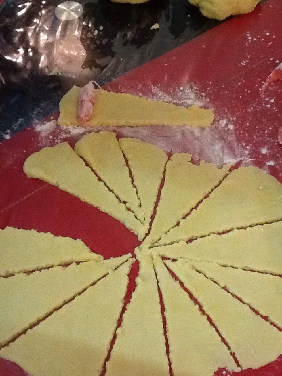 Add one of the small halves onto the thicker end of a strip