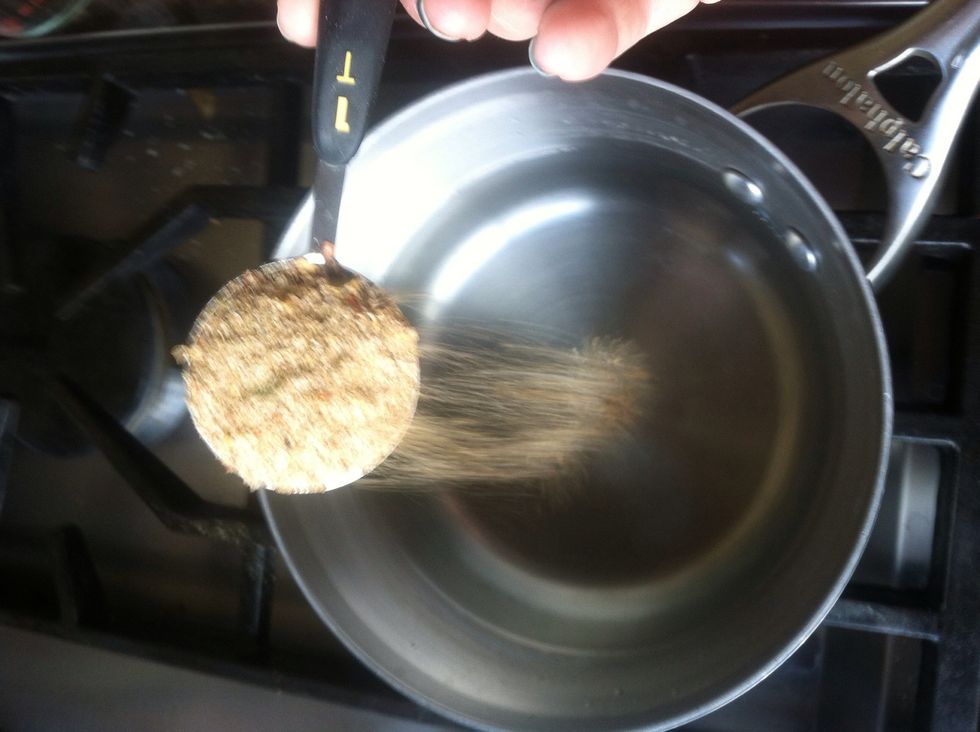 Add one table spoon of the pickling spice to the vinegar and turn on medium heat.