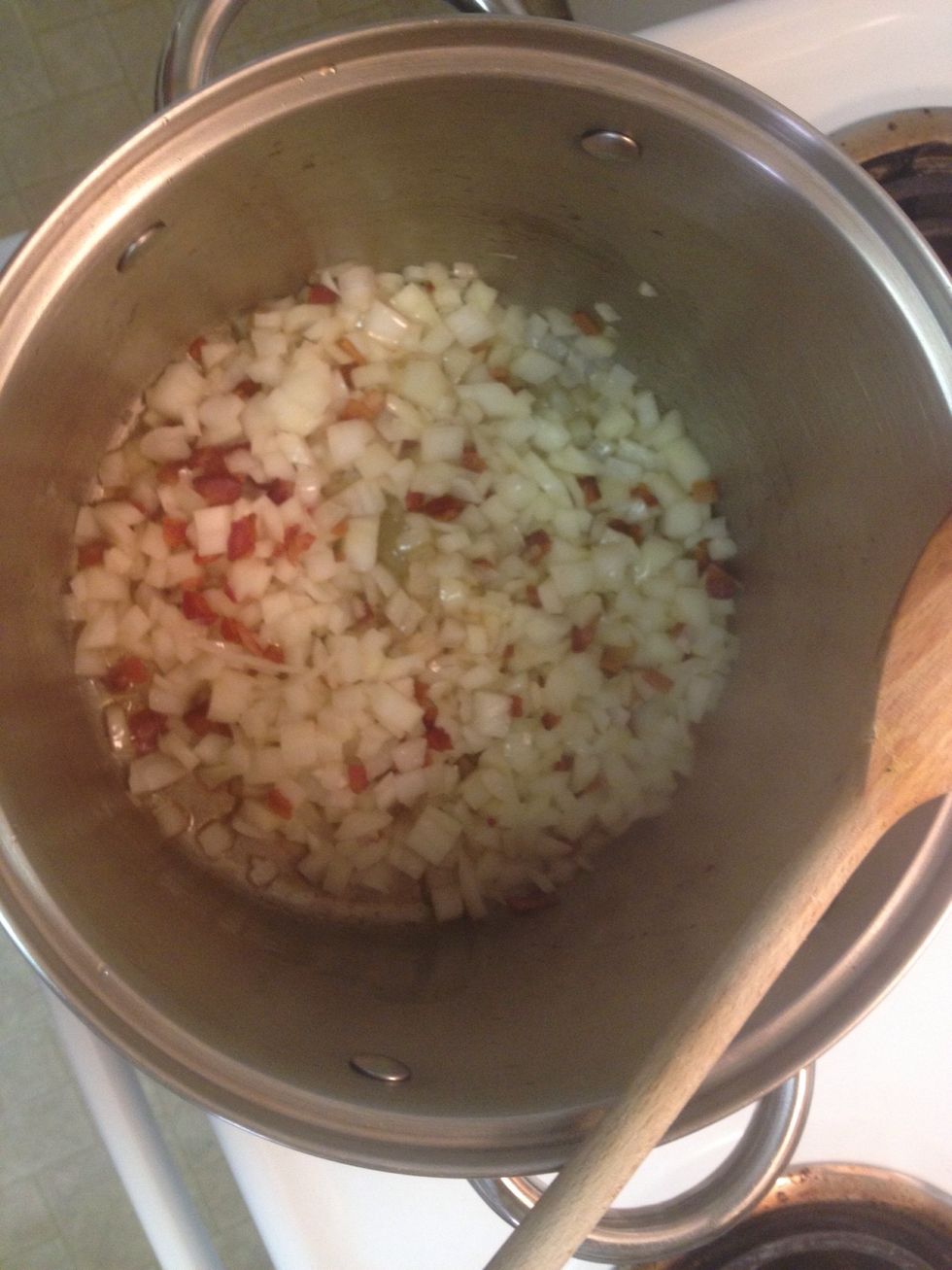 Add onion and minced garlic. Give a good stir. Cook for 10 or so minutes until onion and garlic are soft and fragrant