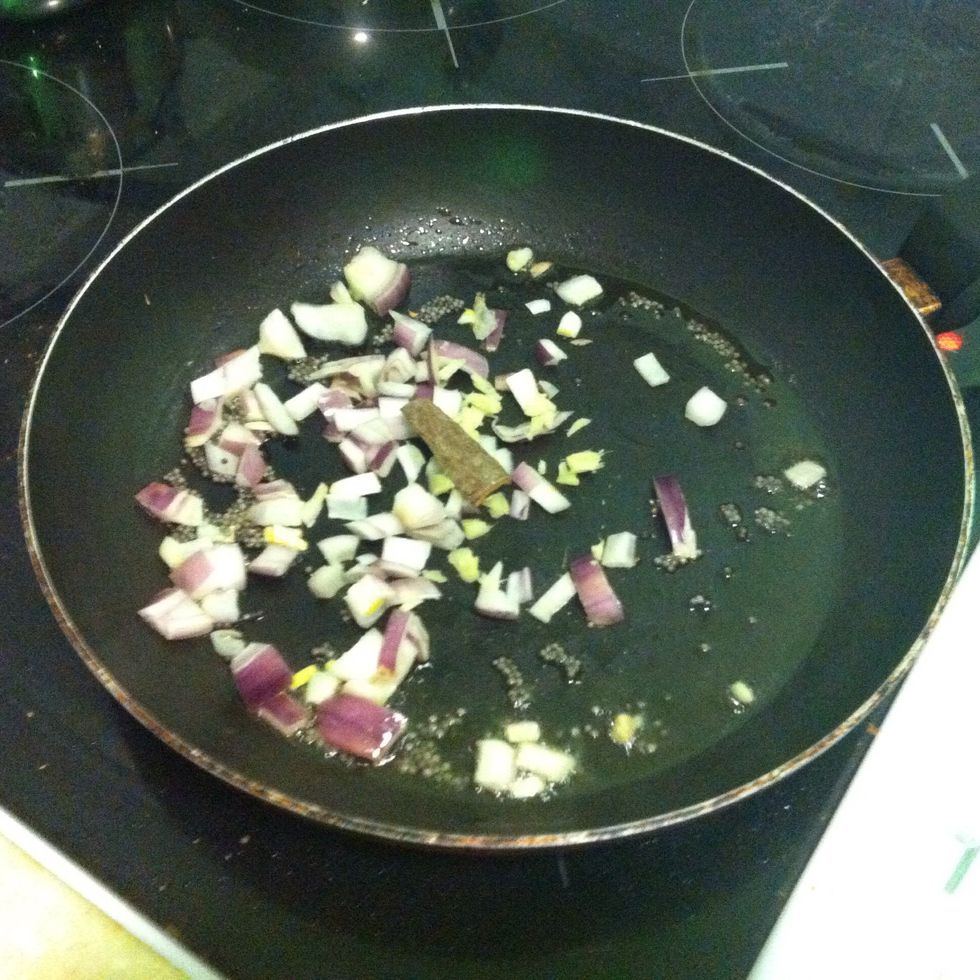 Add onion, ginger, and cinnamon sticks to the frying pan
