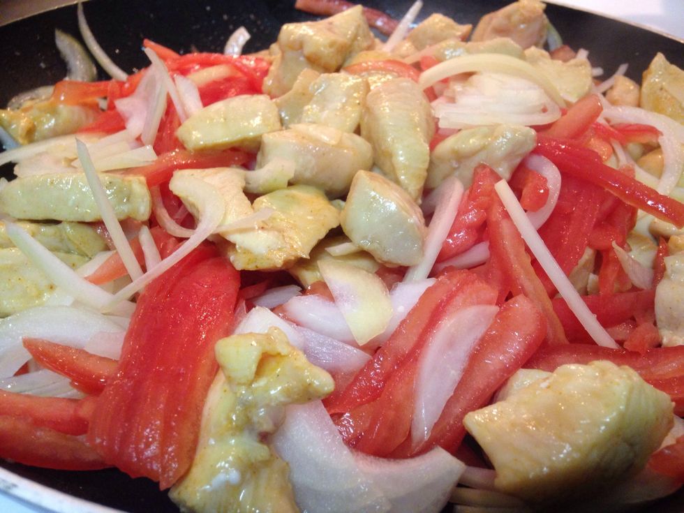 Add onions, tomatoes, and minced garlic in with the chicken. You want to sweat the onions and tomatoes.