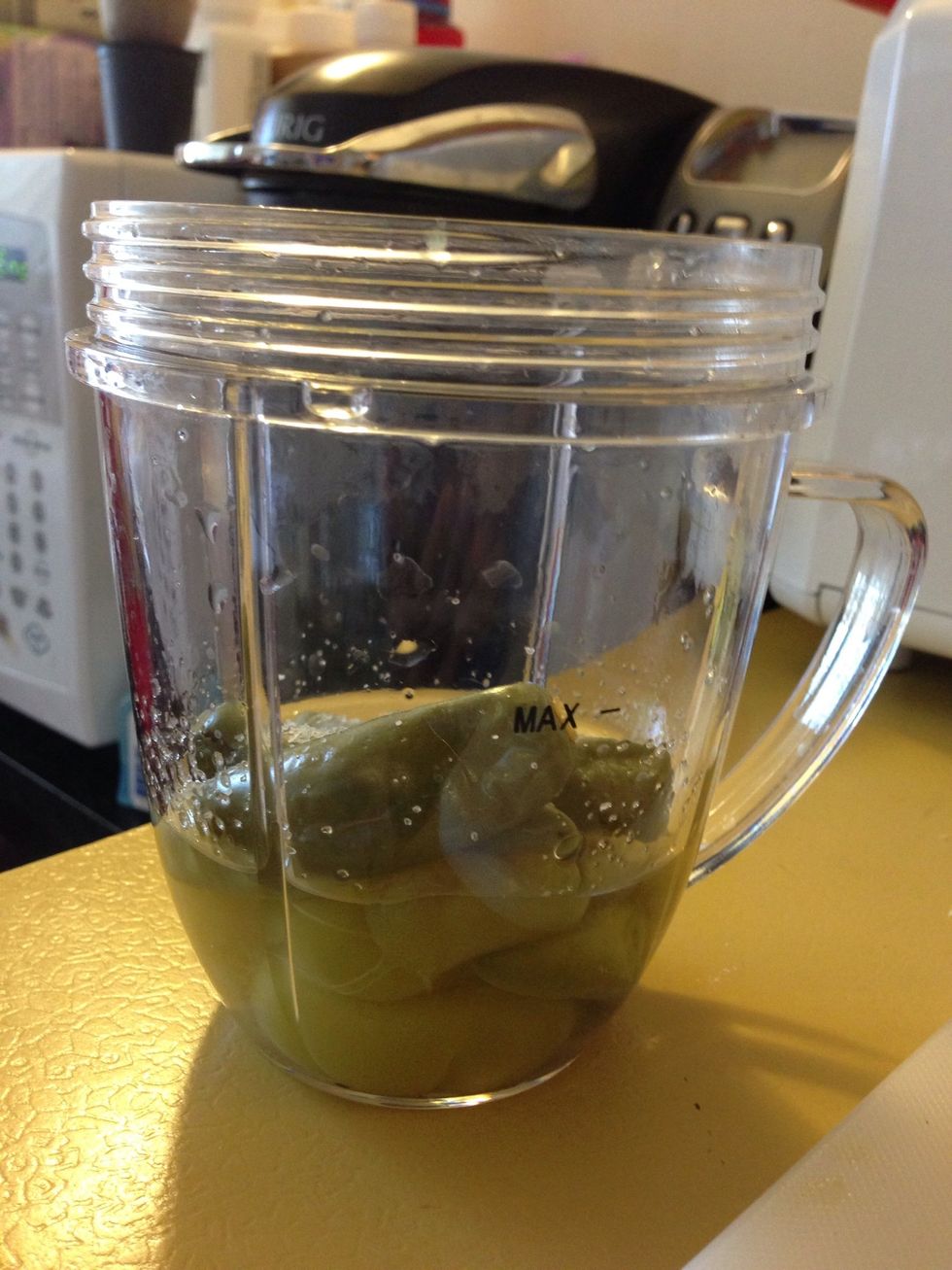 Add only half of what you have in peppers of water. Example, you can see the peppers are at the MAX line on my cup, I added water only to cover half of the peppers. Add 1 teaspoon of salt. Blend.