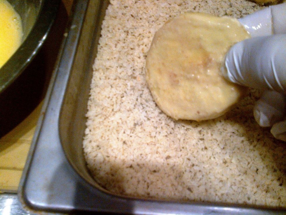Add oregano and basil to the panko crumbs, then coat the eggplant evenly.