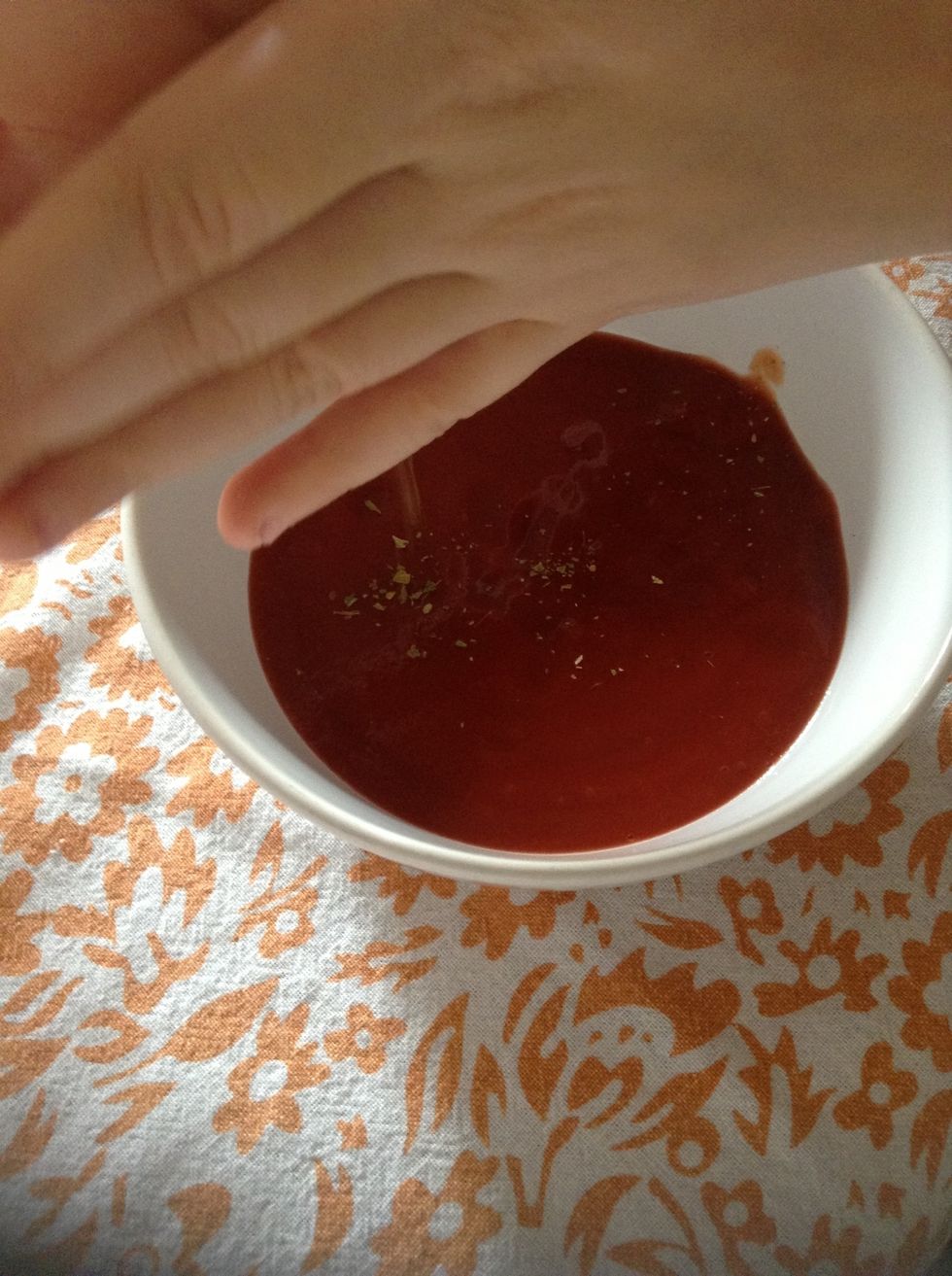 Add oregano to the tomato puree
