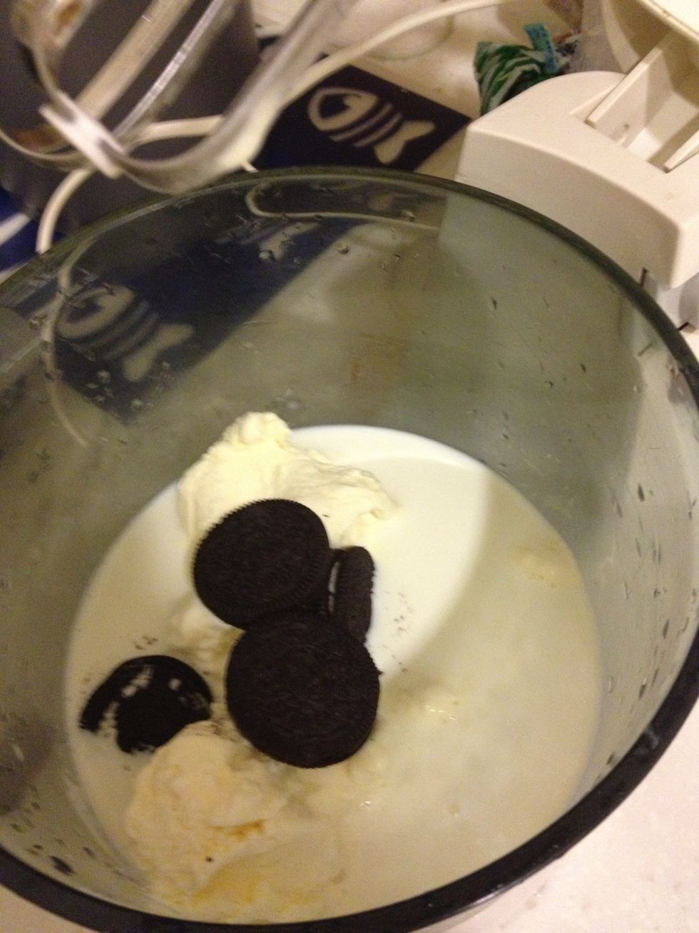 Add Oreos together with milk and ice cream in a blender.