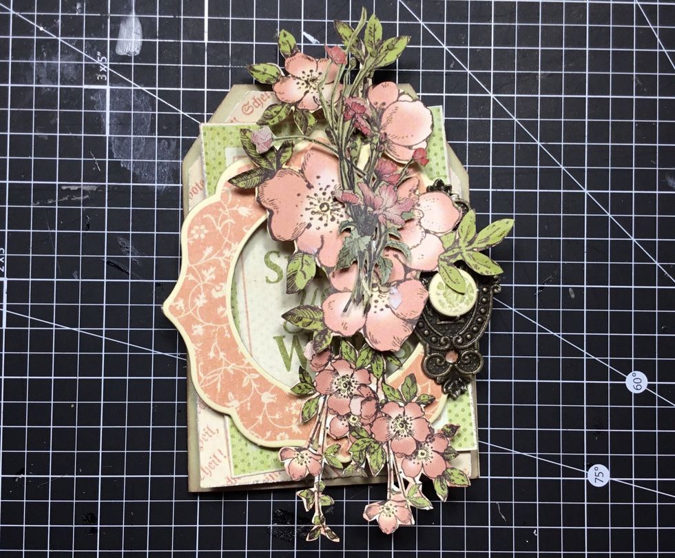 Add other fussy cut flowers and chipboard button as shown.