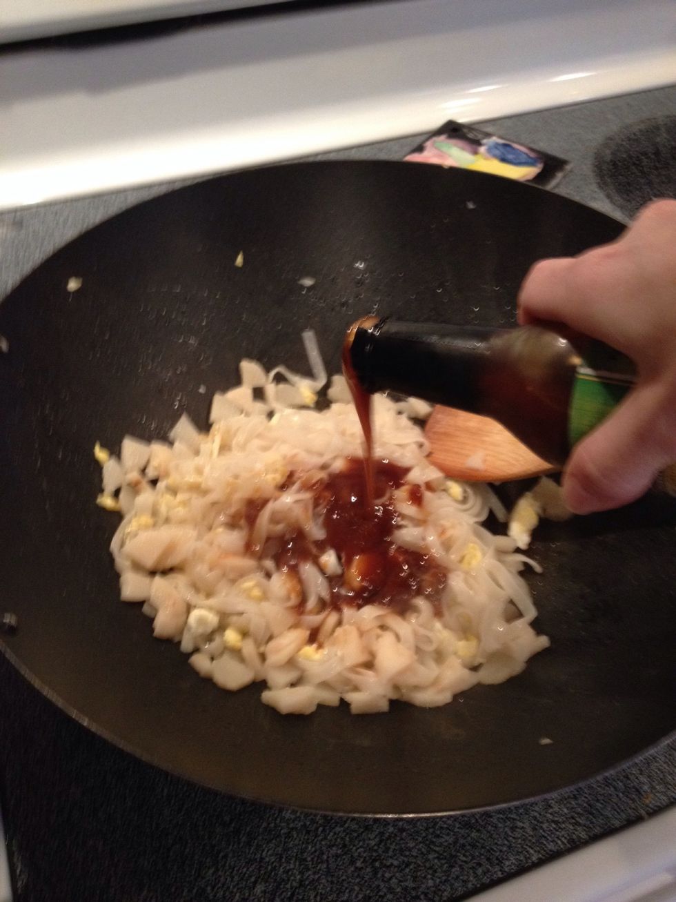 Add Pad Thai sauce. You can just pour it in from the bottle if you like, but don't drown your noodles! (Sorry for the blurry pic, it was all happening so quickly and I needed to stir the noodles!)