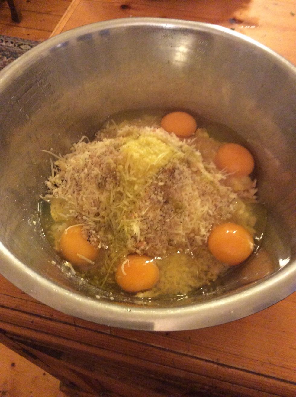 Add parmesan, eggs, breadcrumbs, ground pepper and oil to bowl.