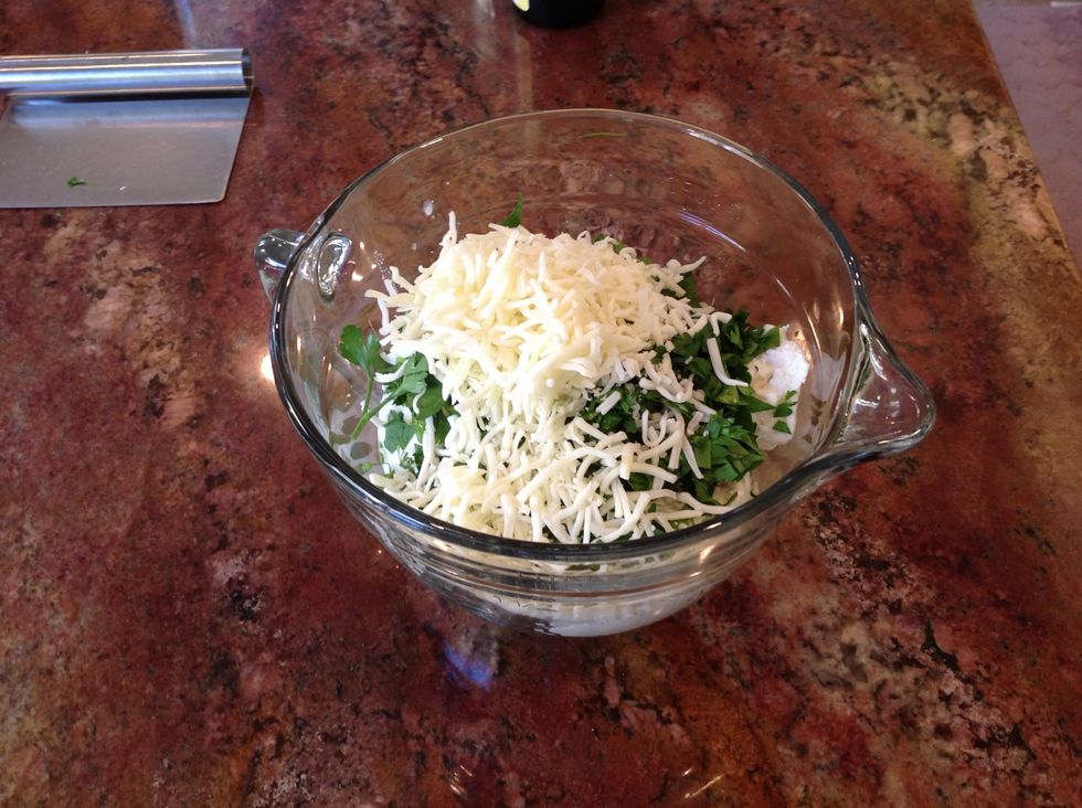 Add parsley, 2 cups mozzarella and Parmesan. Mix.