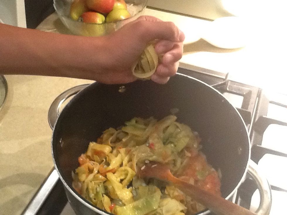 Add pasta by breaking it by hand into the pot and stir through